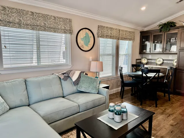 a kitchen with stainless steel appliances granite countertop a refrigerator a stove and a sink with wooden cabinets