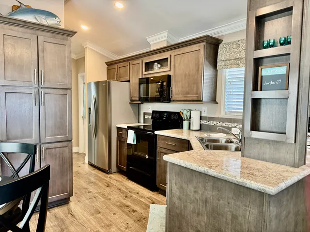 a kitchen with a sink stove and microwave