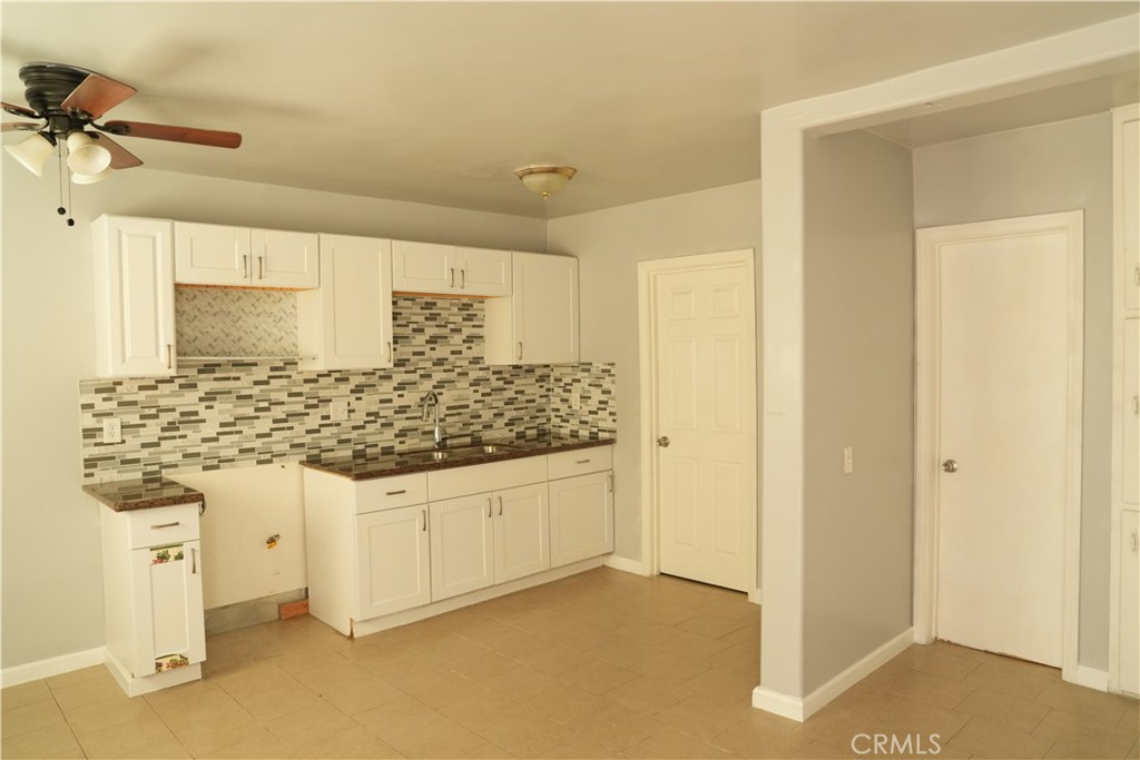 230 North Millard Avenue Rialto, CA 92376 - Photo 8 of 10 a bathroom with a granite countertop sink and a mirror