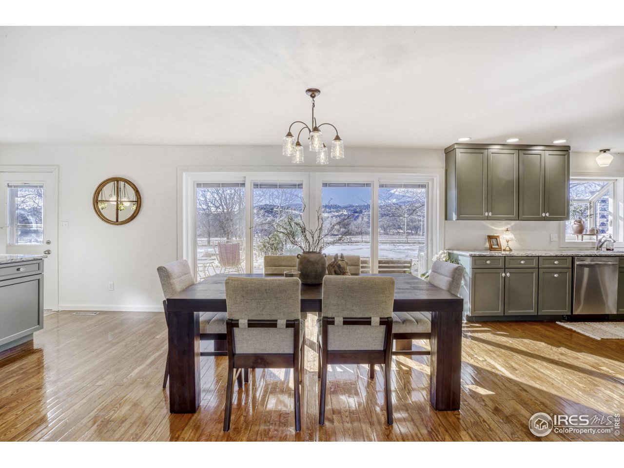 6921 Ridge Valley Court Loveland, CO 80538 - Photo 9 of 50 a view of a dining room with furniture and wooden floor