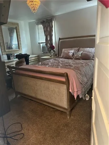 a bedroom with a bed and window
