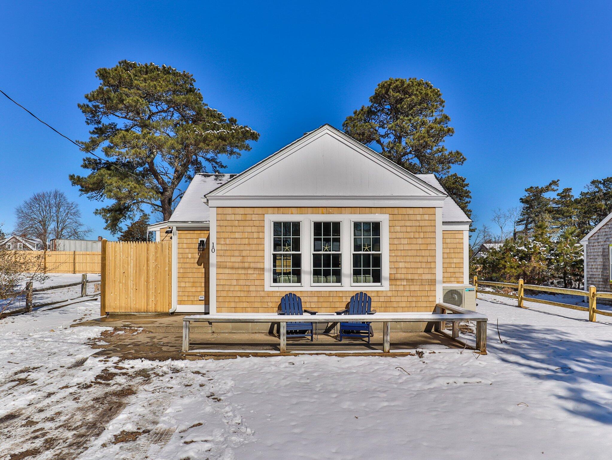 a backyard of a house with table and chairs