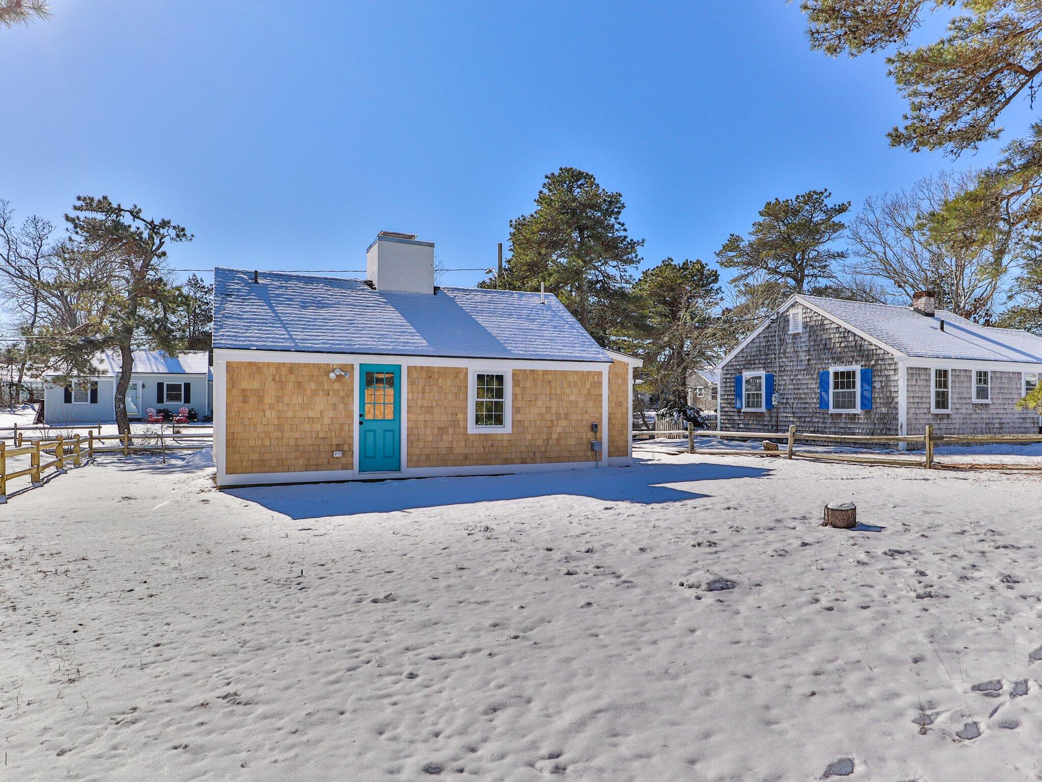 10 Heintz Road Dennis Port, MA 02639 - Photo 15 of 15 a front view of a house with a yard covered with snow in front of house
