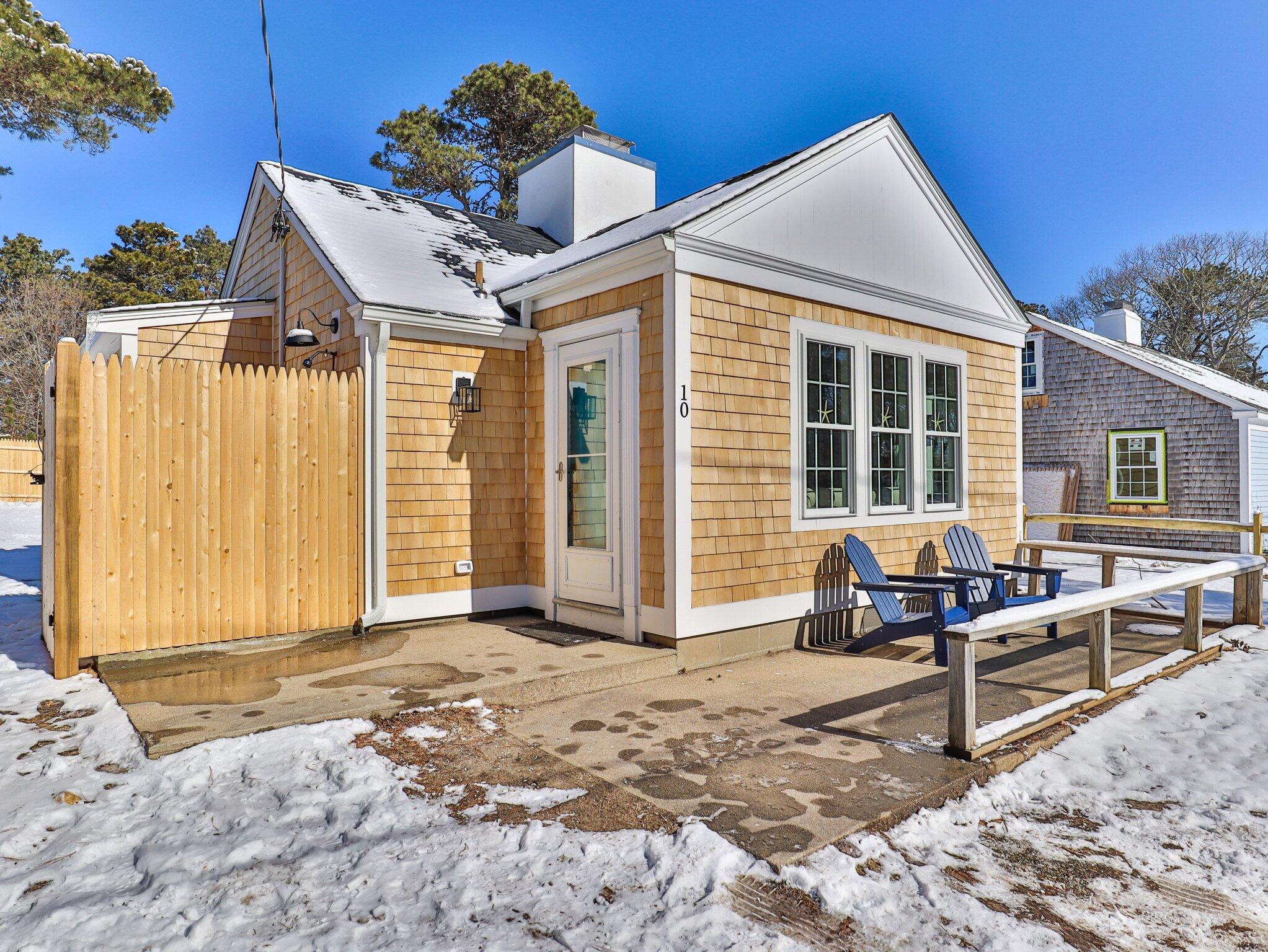 10 Heintz Road Dennis Port, MA 02639 - Photo 2 of 15 a blue bench sitting in front of a house