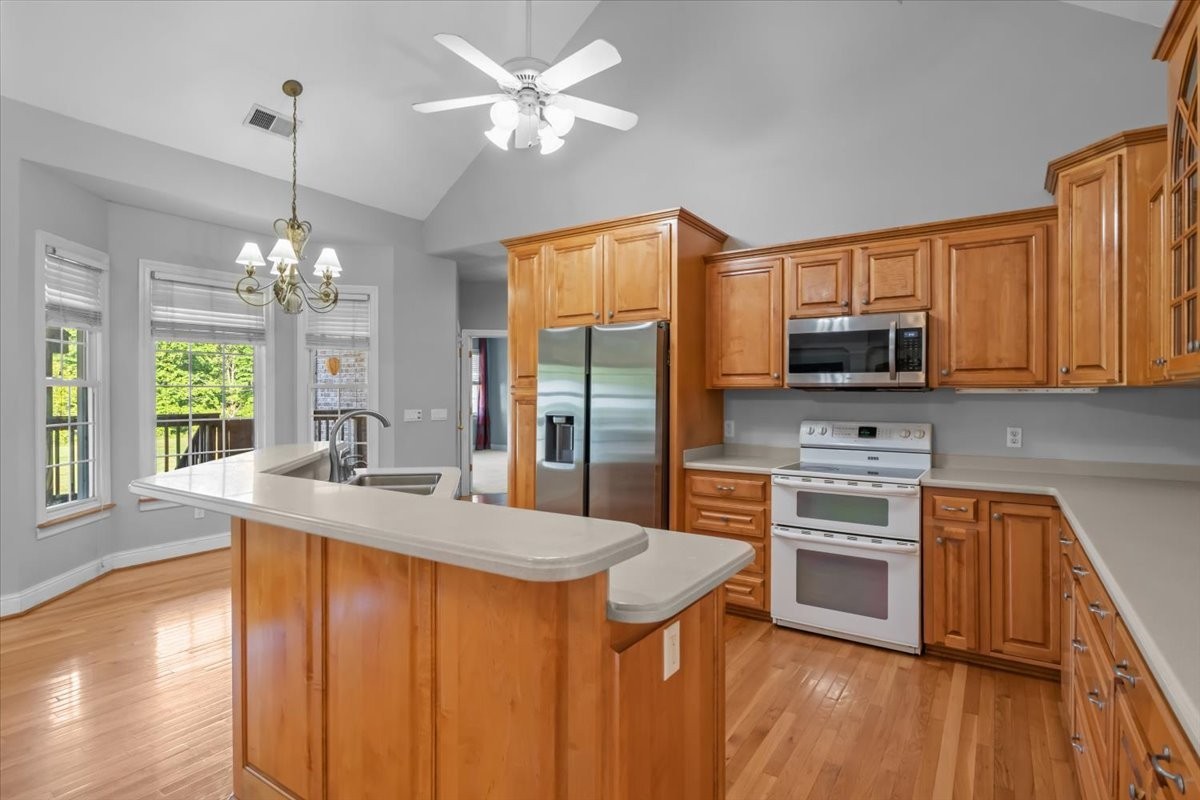 2440 Maple Grove Road Dickson, TN 37055 - Photo 20 of 99 a kitchen with stainless steel appliances granite countertop a sink stove and refrigerator