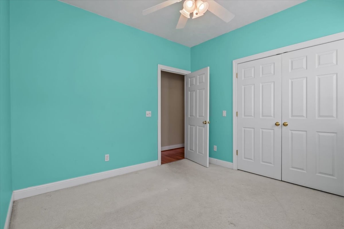 2440 Maple Grove Road Dickson, TN 37055 - Photo 29 of 99 an empty room with closet and chandelier fan