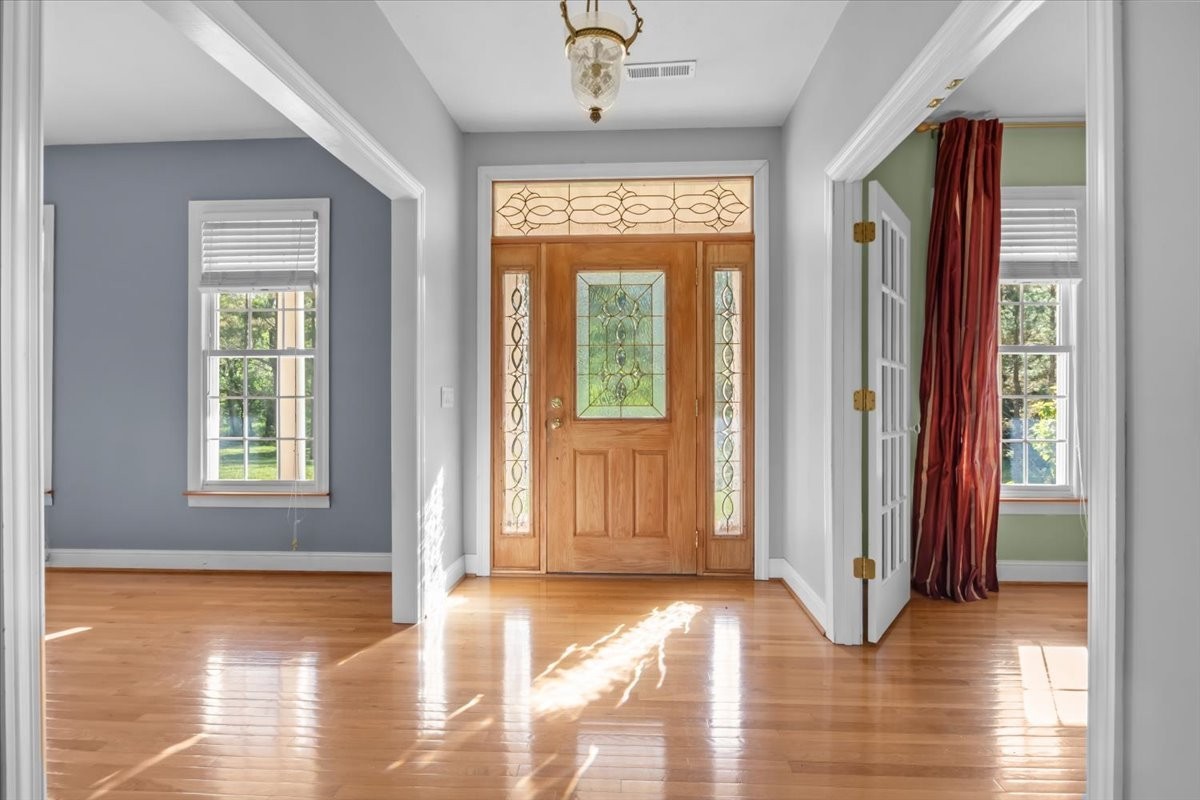 2440 Maple Grove Road Dickson, TN 37055 - Photo 6 of 99 a view of a hallway with wooden floor and windows