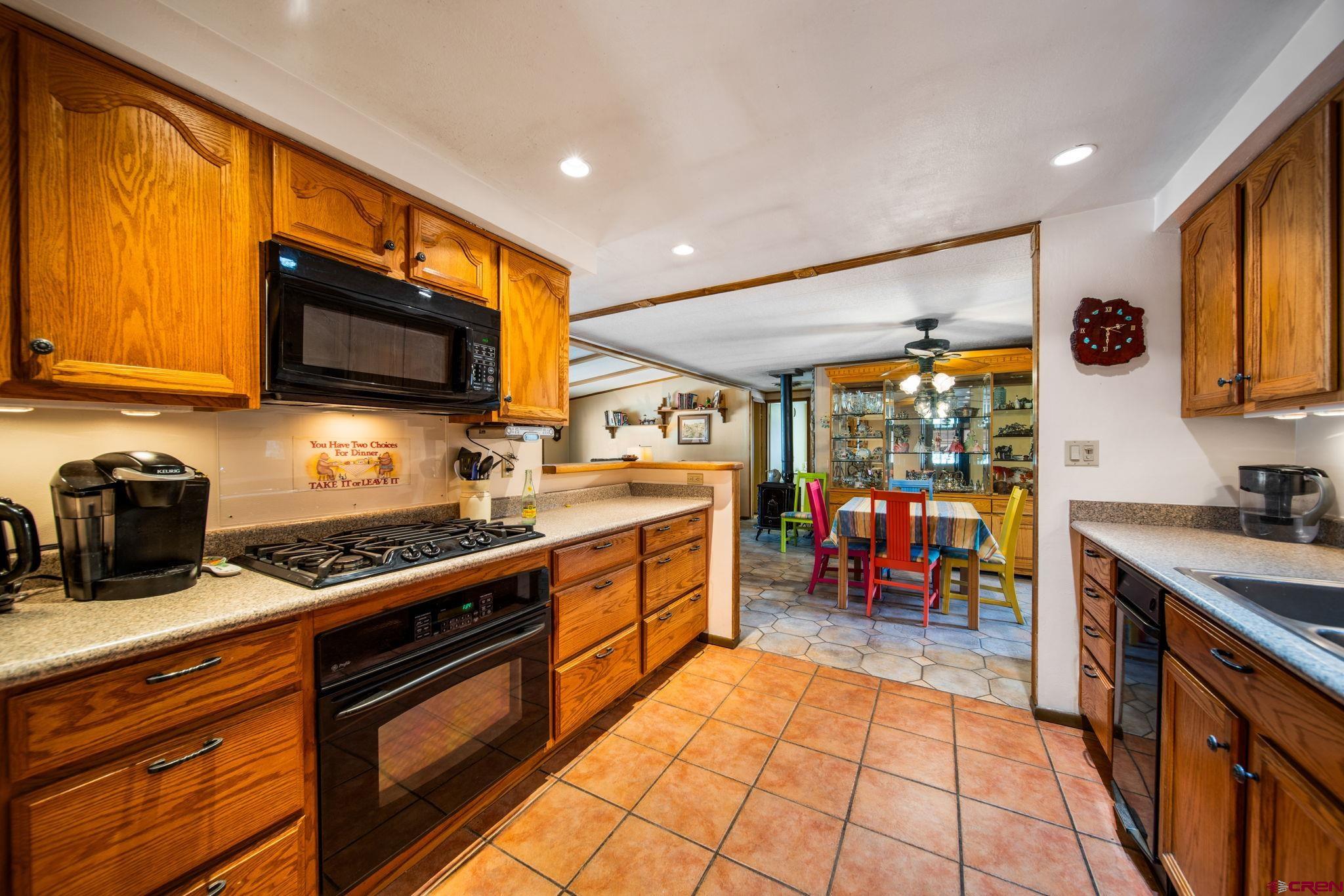 7853 County Road 334 Ignacio, CO 81137 - Photo 11 of 39 a kitchen with stainless steel appliances granite countertop a stove and a sink