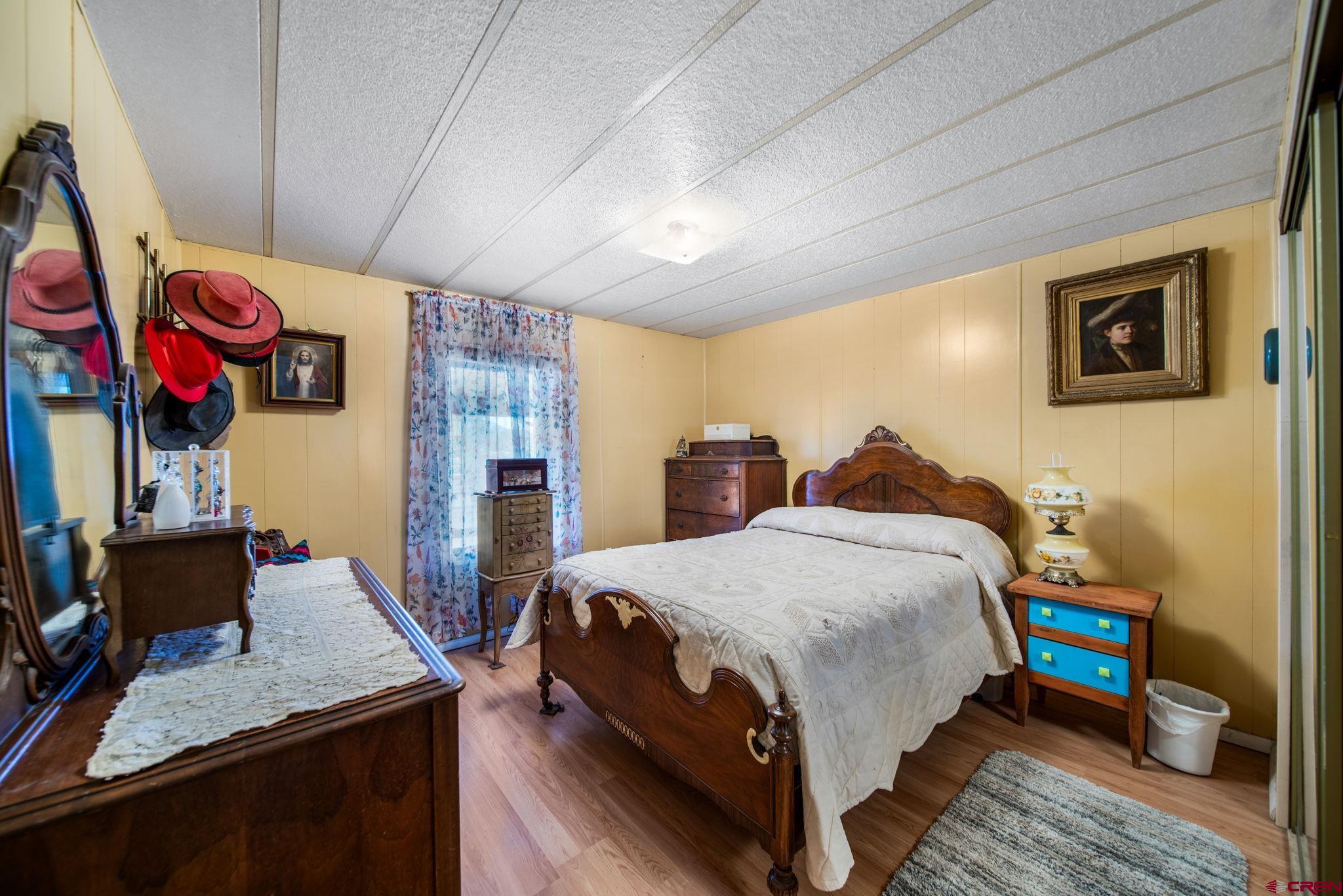 7853 County Road 334 Ignacio, CO 81137 - Photo 17 of 39 a bedroom with a bed and wooden floor