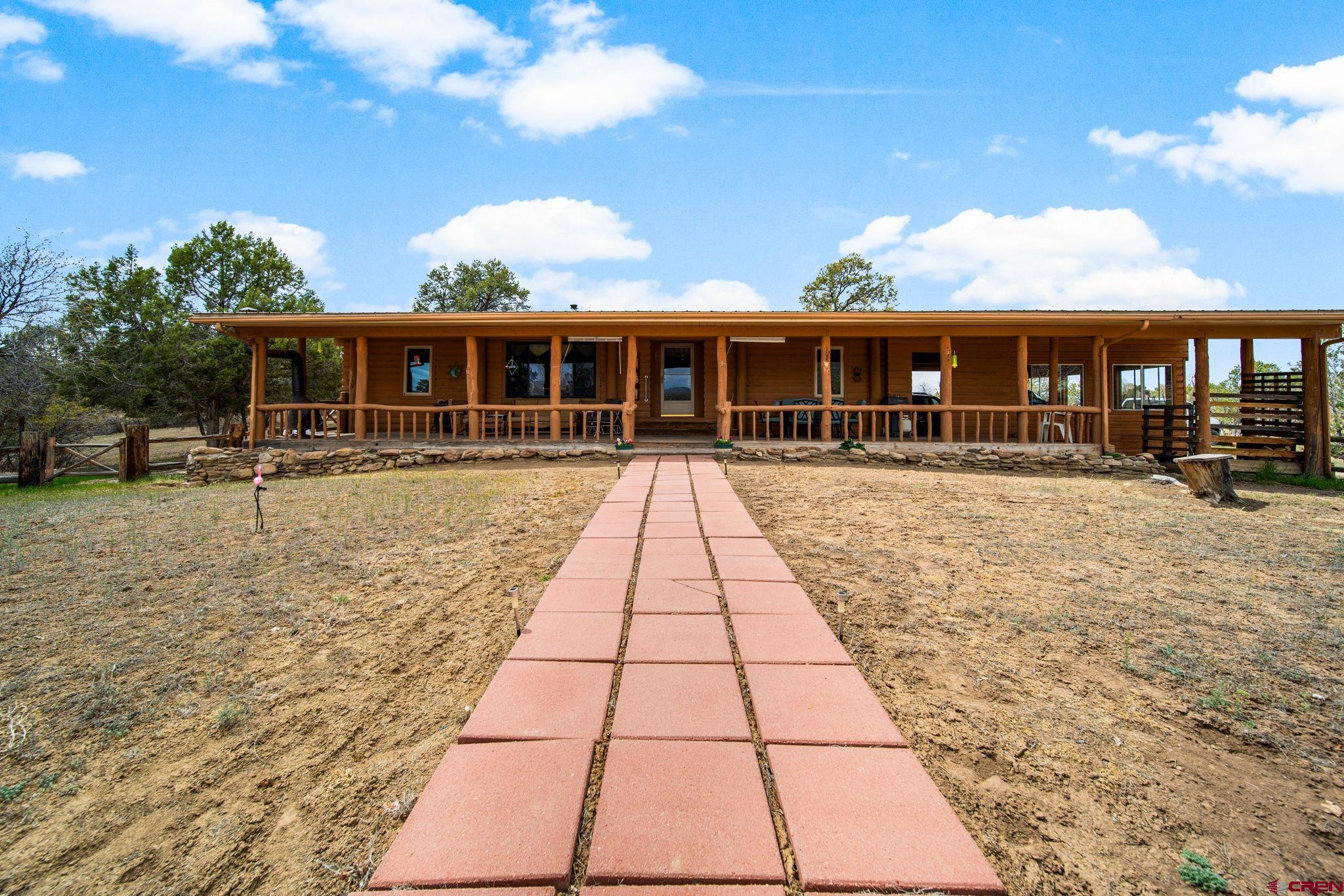 7853 County Road 334 Ignacio, CO 81137 - Photo 4 of 39 a front view of house with yard and trees in the background