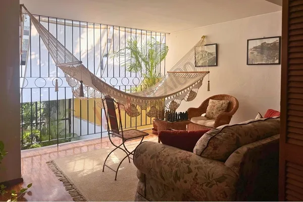 a living room with a couch and a chandelier