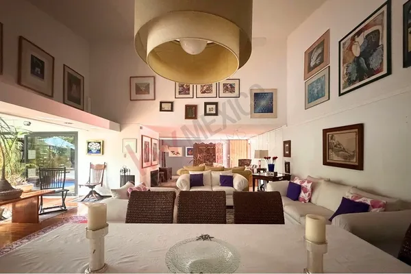 a living room with furniture fireplace and a large window