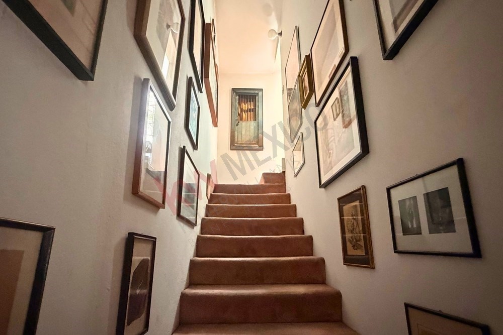 36 Perugino Bath, undefined 03740 - Photo 21 of 29 a view of staircase with lots of frames on wall and a glass door