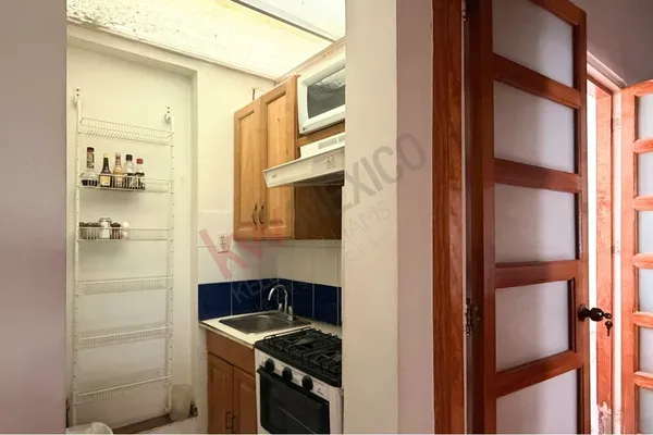 a bedroom with a bed and a table with chair