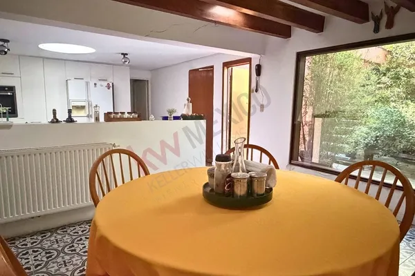 a dining room with furniture and window