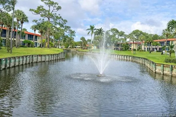 a view of a lake with houses in the background