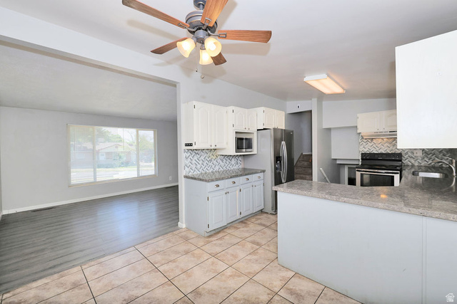 1272 Cook Street Ogden, UT 84404 - Photo 12 of 46 Kitchen featuring white cabinetry, grey countertops, stainless steel appliances, and a patterned tile backsplash