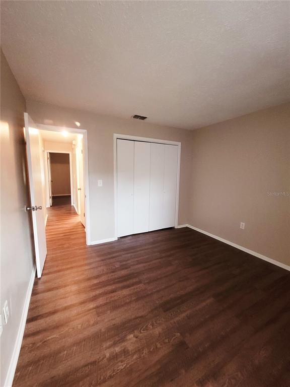 4331 Azora Road Spring Hill, FL 34608 - Photo 11 of 16 a view of a big room with wooden floor and windows