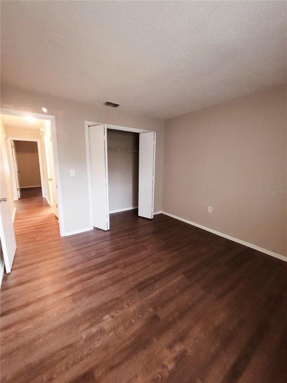 4331 Azora Road Spring Hill, FL 34608 - Photo 12 of 16 a view of empty room with wooden floor
