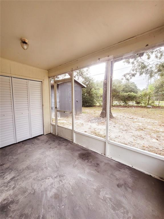 4331 Azora Road Spring Hill, FL 34608 - Photo 16 of 16 a view of an empty room with a sliding door