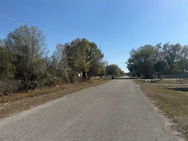 a view of a road with a building in the background