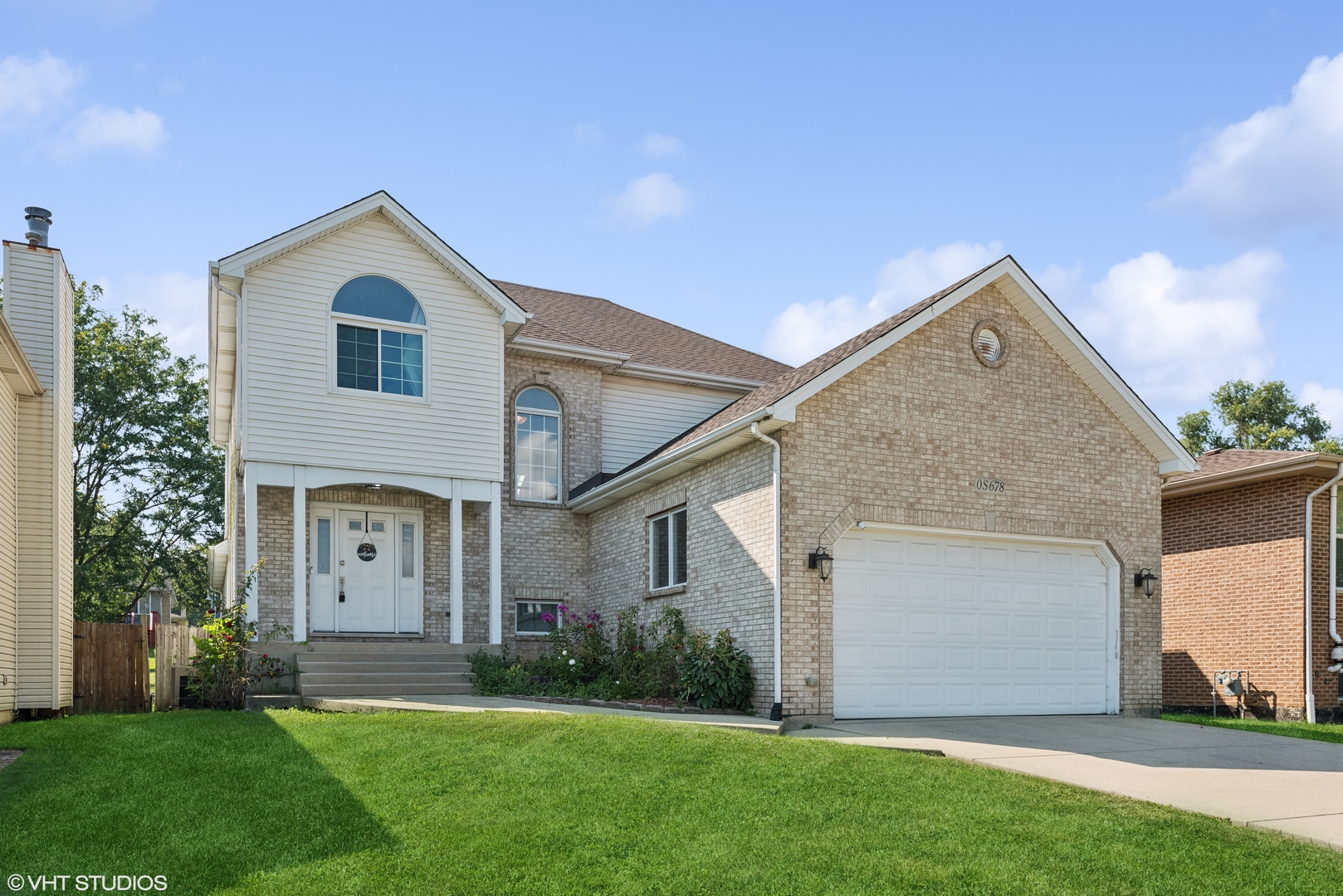 S678 Robbins Street Winfield, IL 60190 - Photo 1 of 1 a view of a white house next to a yard and large trees