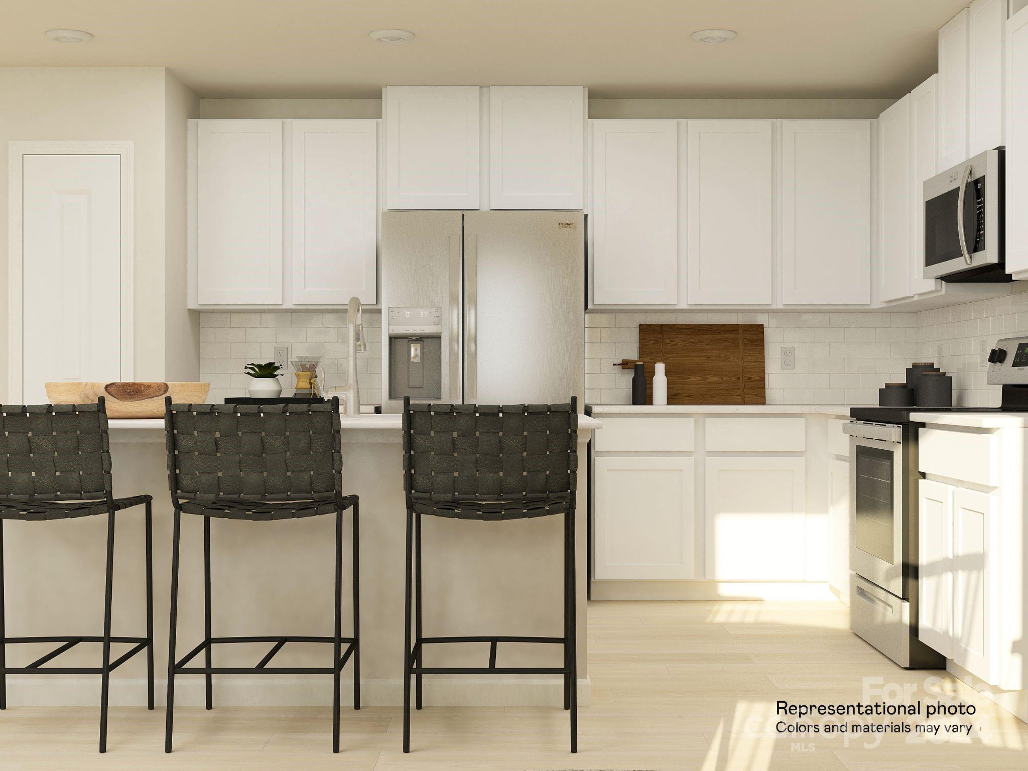 627 Mile Crk Road, Unit 69 Edgemoor, SC 29712 - Photo 6 of 16 a kitchen with stainless steel appliances kitchen island granite countertop a refrigerator and microwave