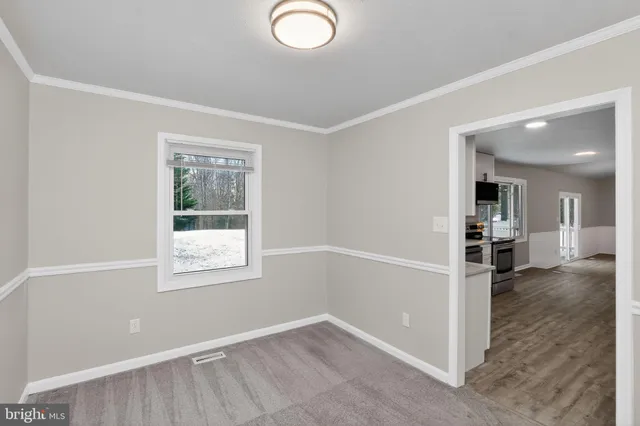 an empty room with windows and entrance