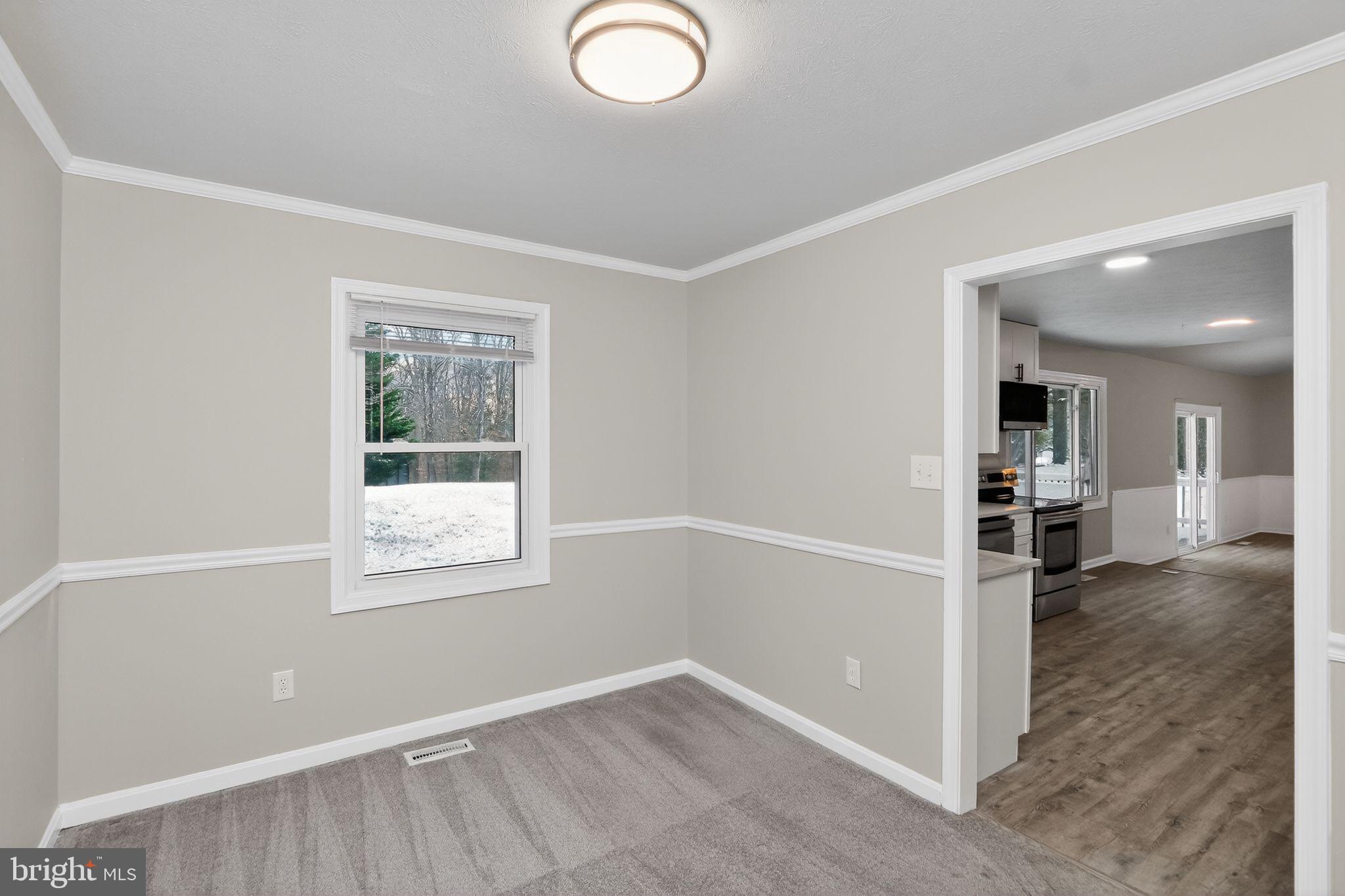 11979 Falling Creek Drive Manassas, VA 20112 - Photo 11 of 30 an empty room with windows and entrance