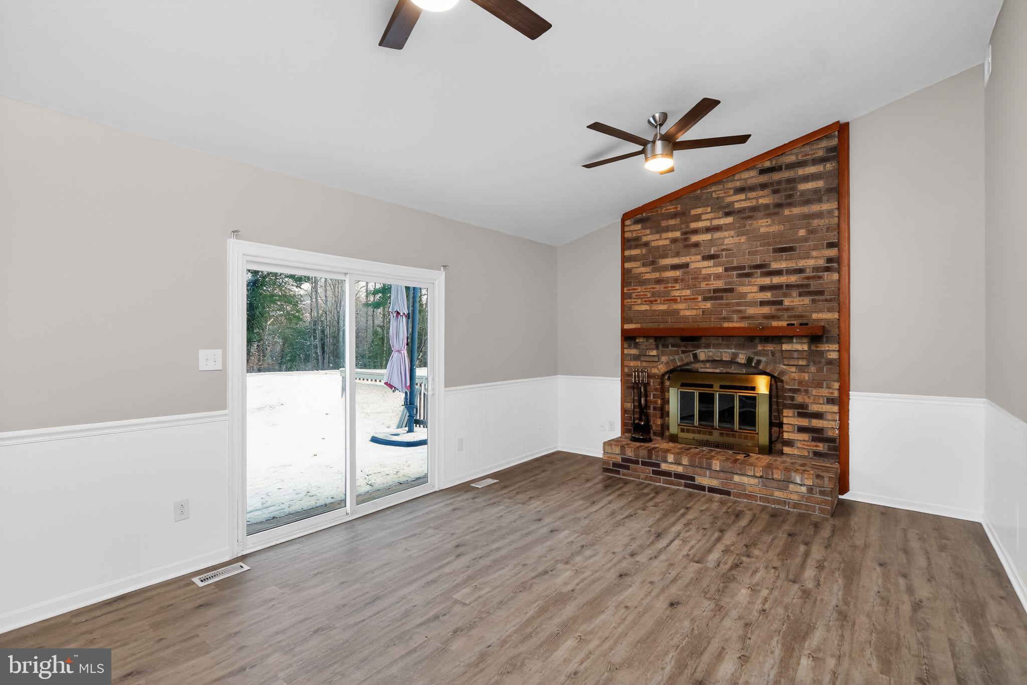 11979 Falling Creek Drive Manassas, VA 20112 - Photo 16 of 30 a living room with furniture and a fireplace