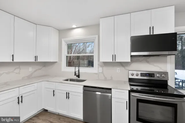 a kitchen with a sink and white cabinets