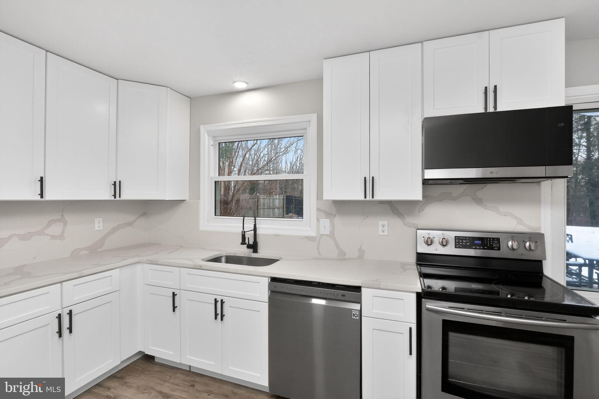 11979 Falling Creek Drive Manassas, VA 20112 - Photo 19 of 30 a kitchen with a sink and white cabinets