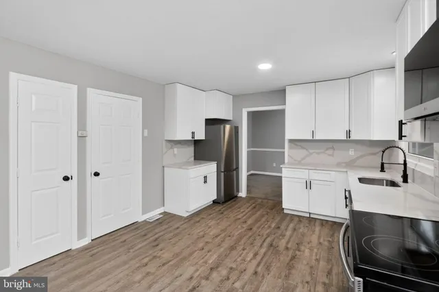 a kitchen with stainless steel appliances a stove sink and cabinets