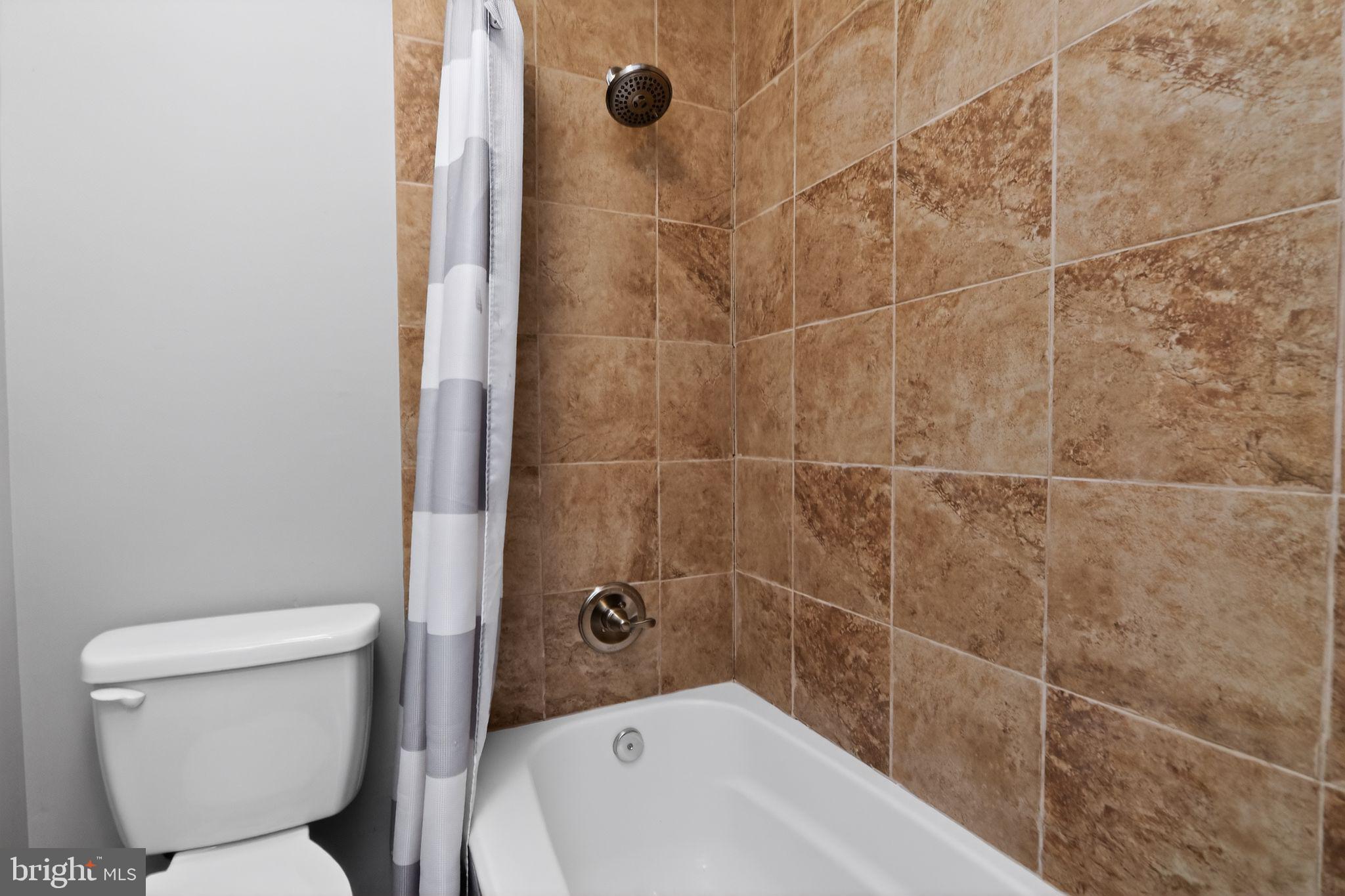 11979 Falling Creek Drive Manassas, VA 20112 - Photo 28 of 30 a bathroom with a toilet and shower