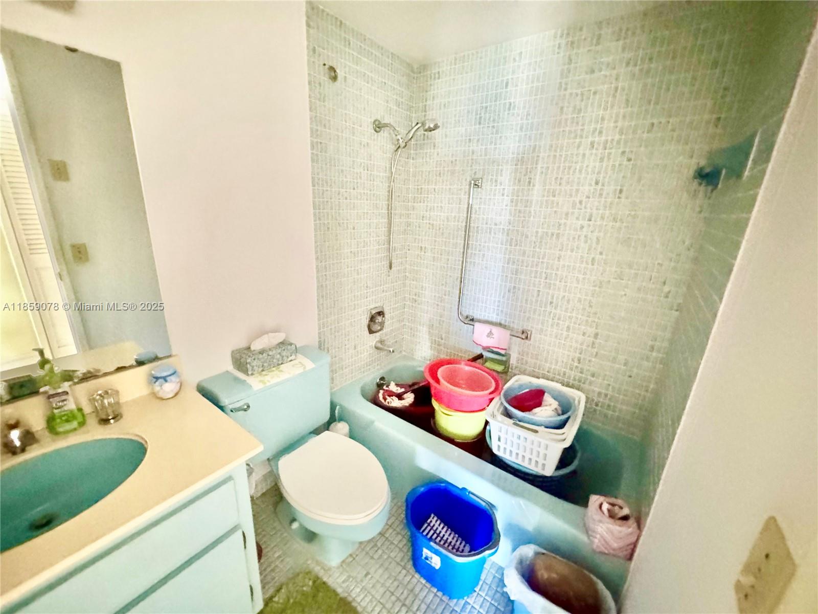 4400 Hillcrest Drive, Unit 520C Hollywood, FL 33021 - Photo 13 of 18 a bathroom with a sink mirror vanity and toilet