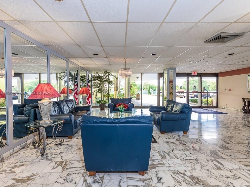 4400 Hillcrest Drive, Unit 520C Hollywood, FL 33021 - Photo 14 of 18 a room with lots of tables a large window and chairs