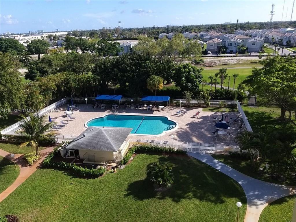 4400 Hillcrest Drive, Unit 520C Hollywood, FL 33021 - Photo 16 of 18 a view of a swimming pool with lawn chairs and plants
