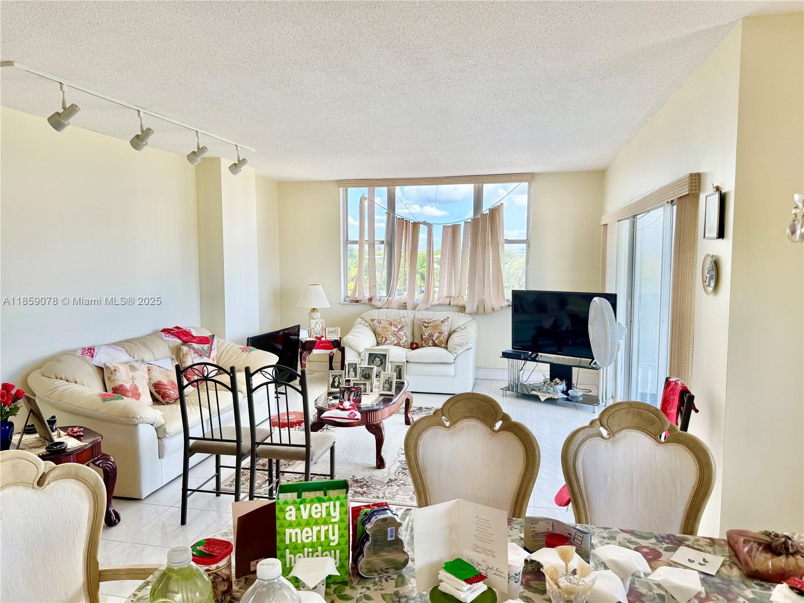 4400 Hillcrest Drive, Unit 520C Hollywood, FL 33021 - Photo 7 of 18 a living room with furniture and a flat screen tv