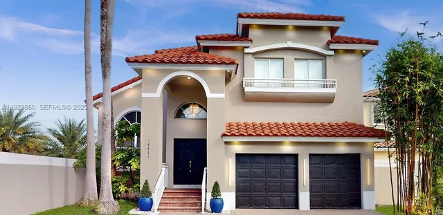 a front view of a house with plants