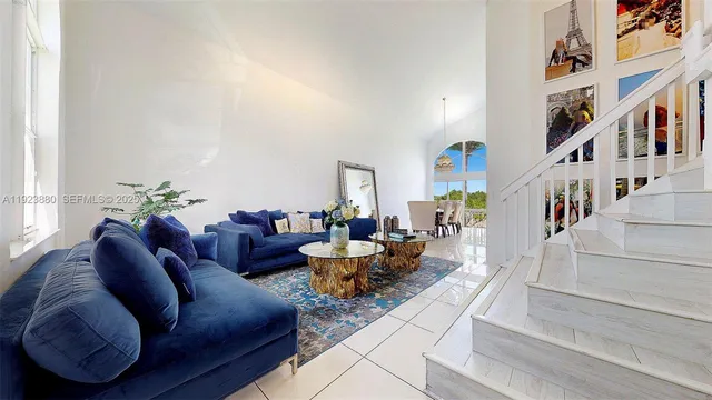 a living room with furniture and stairs