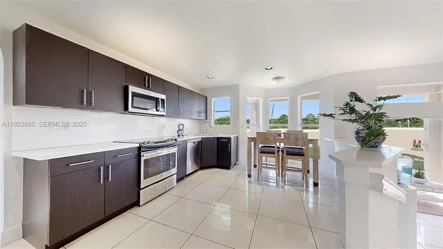 a kitchen with a table and chairs in it