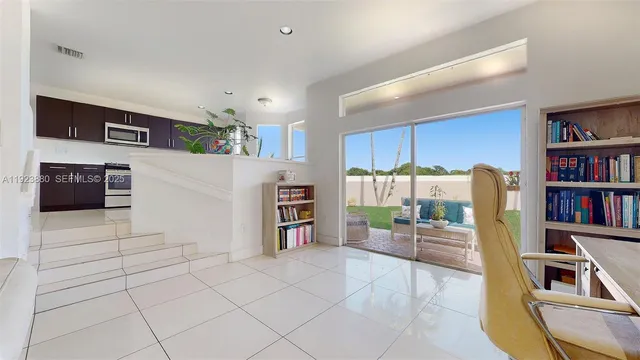 a living room with furniture and a book shelf