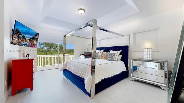 a bedroom with a large bed and a window