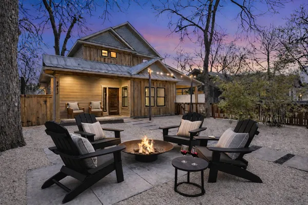 a view of a patio with couches table and chairs and potted plants