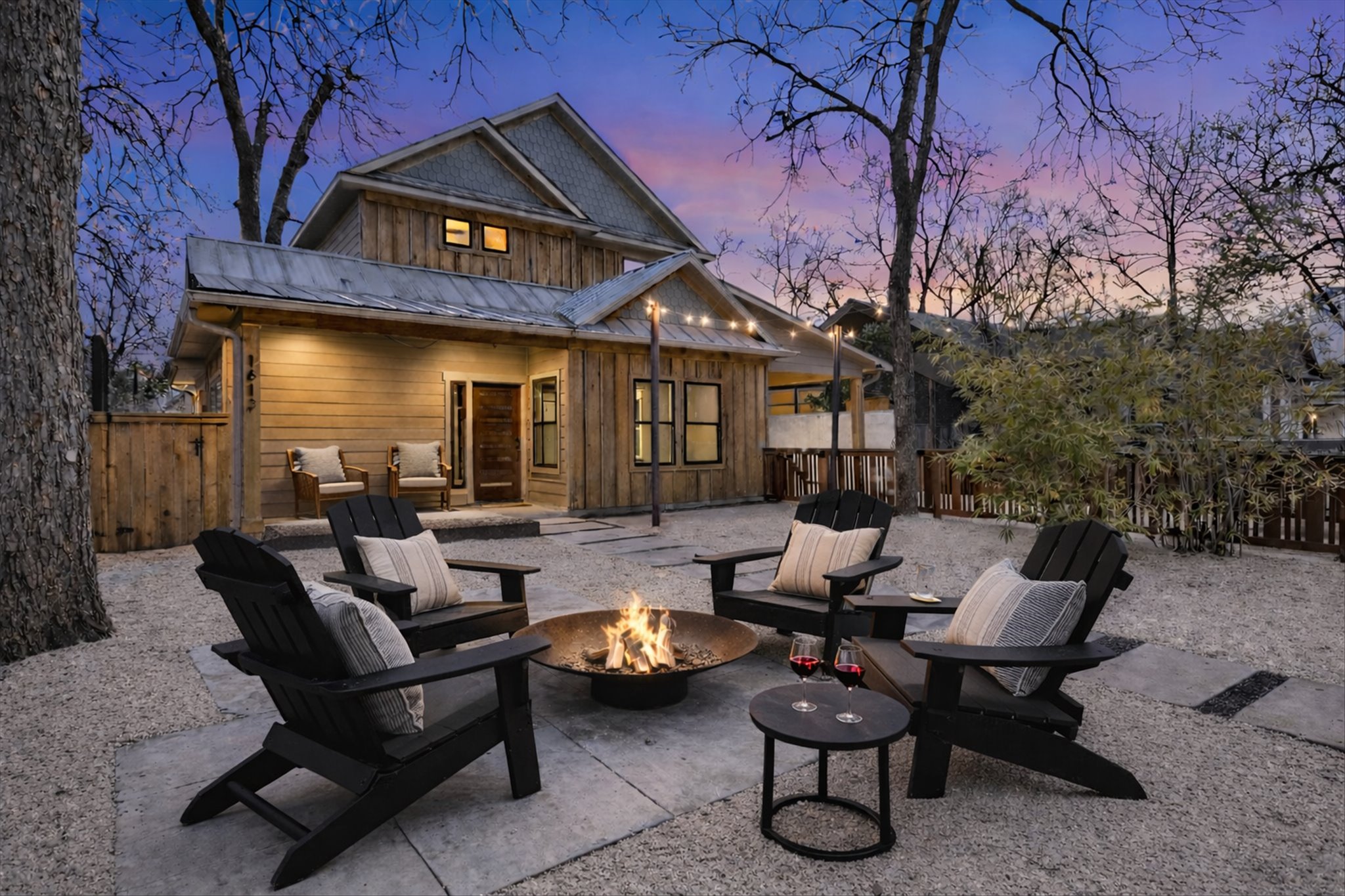 a view of a patio with couches table and chairs and potted plants