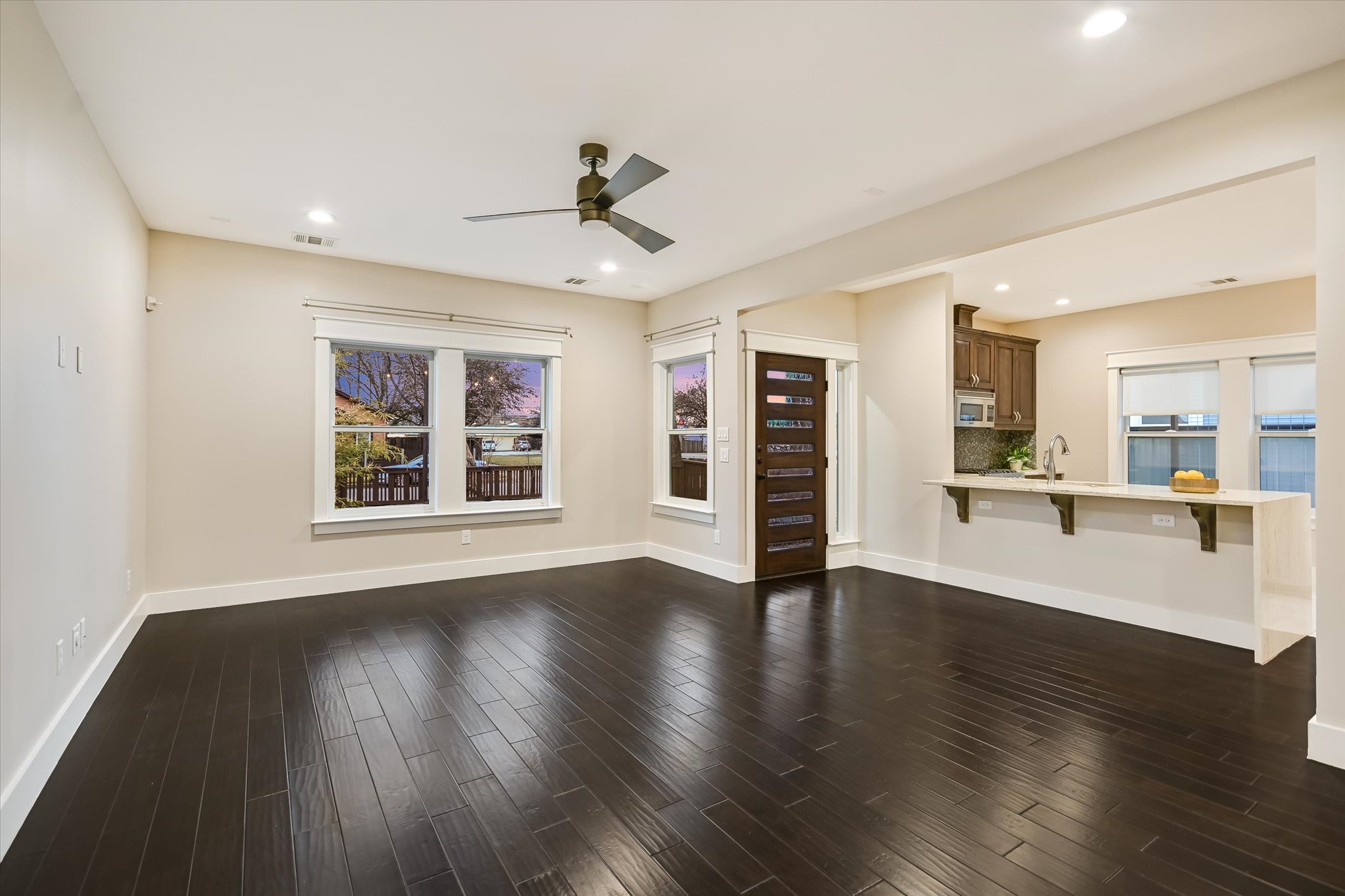 1613 Willow Street Austin, TX 78702 - Photo 5 of 30 a view of an empty room with wooden floor and a window