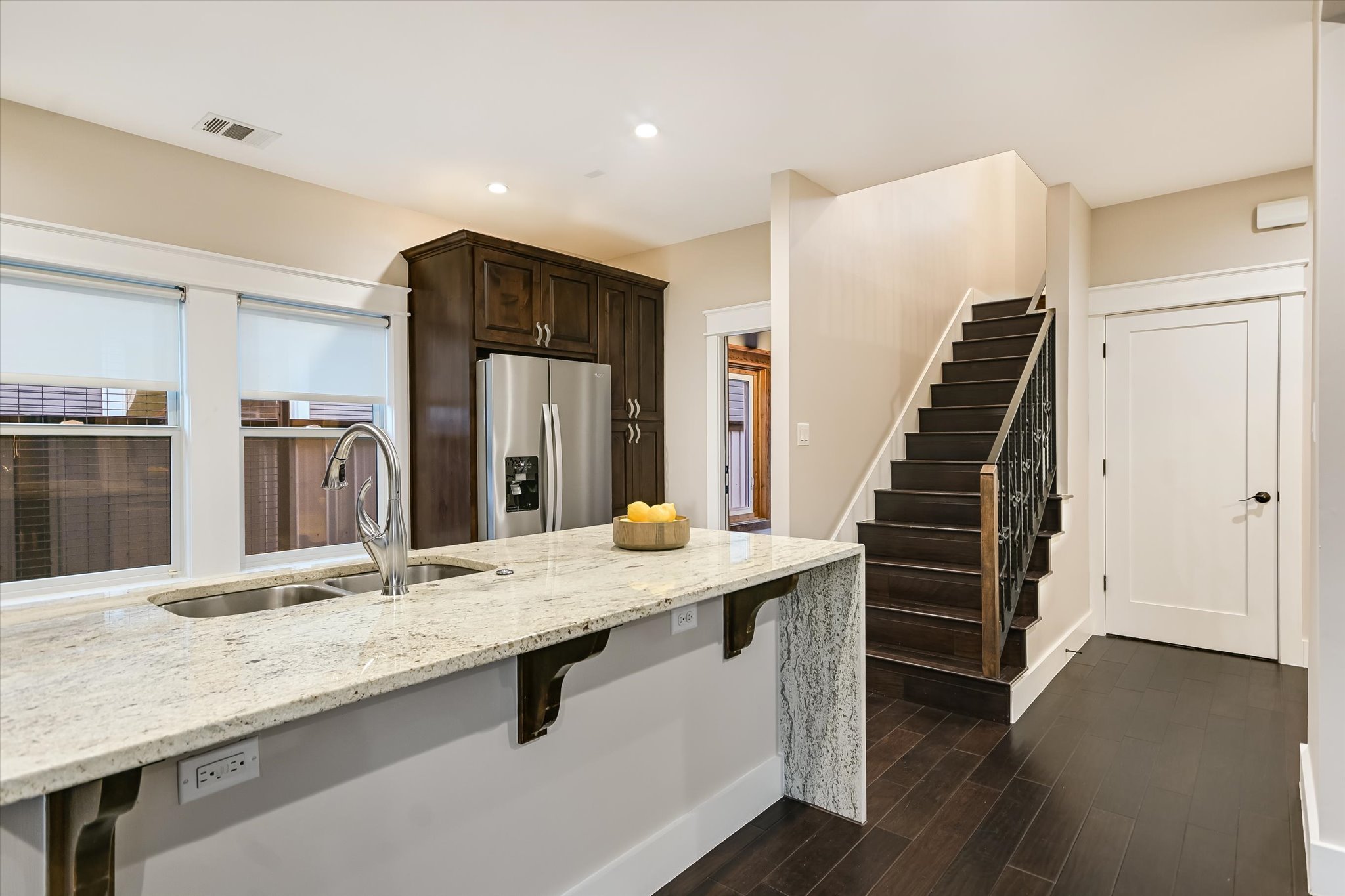 1613 Willow Street Austin, TX 78702 - Photo 9 of 30 a kitchen with granite countertop a sink and refrigerator