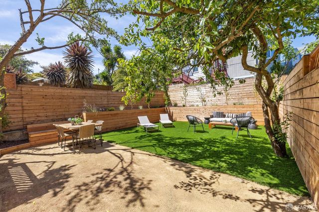 a view of a patio with table and chairs and potted plants