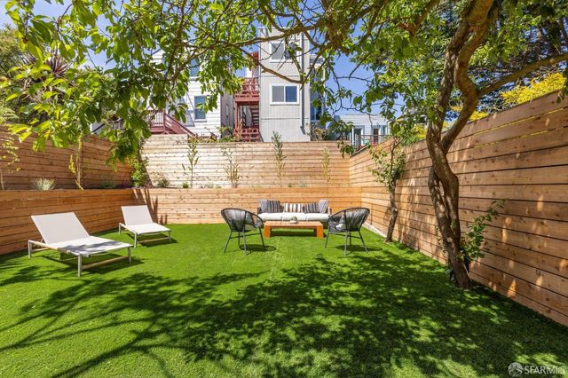 a view of a patio with table and chairs and potted plants with sky view