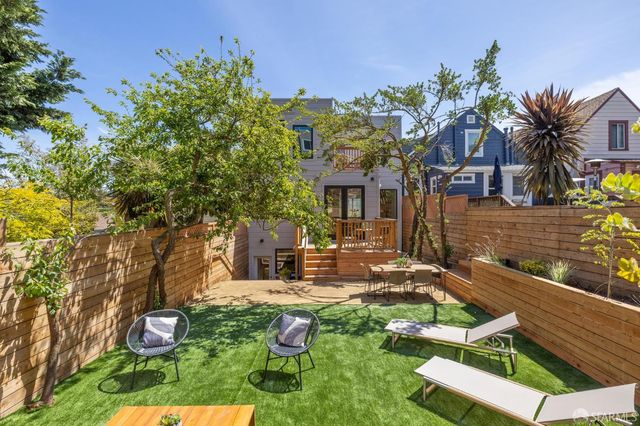 a large kitchen with stainless steel appliances granite countertop a stove a sink a dining table and chairs